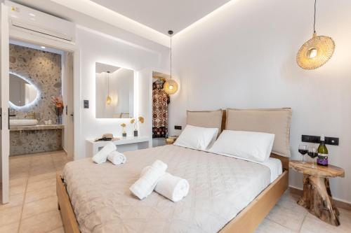 a bedroom with a large bed and a bathroom at Golden Bay in Agios Prokopios