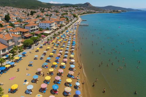 an overhead view of a beach with people and umbrellas at Panorama Hotel Özdere in Ortaköy