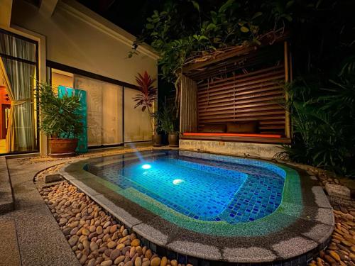 a swimming pool in the middle of a yard at Rose Pool Villa The perfect private oasis in Rawai Beach