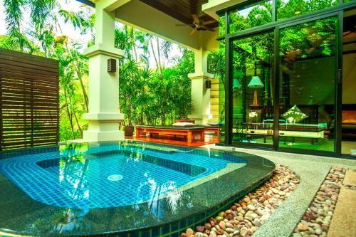 a swimming pool in the middle of a house at Rose Pool Villa The perfect private oasis in Rawai Beach