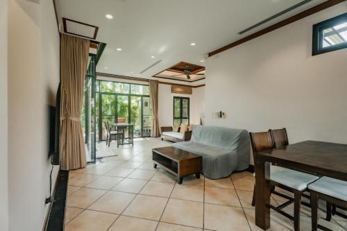 a living room with a couch and a table at Rose Pool Villa The perfect private oasis in Rawai Beach