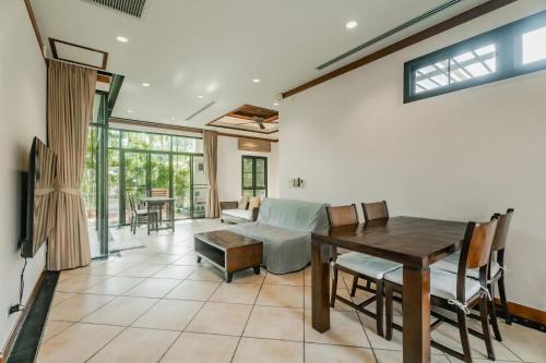 a living room with a table and a couch at Rose Pool Villa The perfect private oasis in Rawai Beach