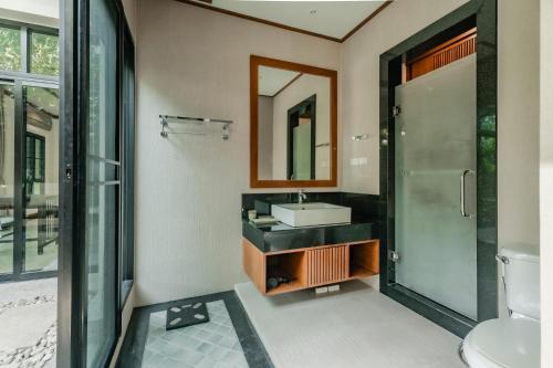 a bathroom with a sink and a mirror at Rose Pool Villa The perfect private oasis in Rawai Beach