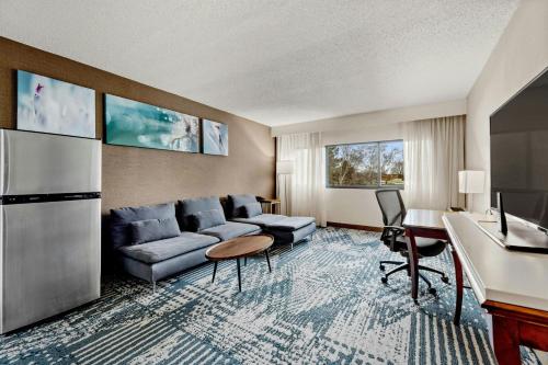 a living room with a couch and a table at Delta Hotels by Marriott Mount Pleasant in Racine