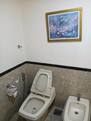 a bathroom with a toilet and a sink at My Service Suites Times Square KL in Kuala Lumpur