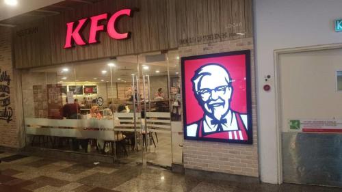 a kfc restaurant with a large sign on the door at My Service Suites Times Square KL in Kuala Lumpur