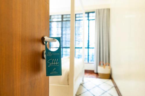 a room with a door with a sign on it at Riverside Park Complex in Nairobi