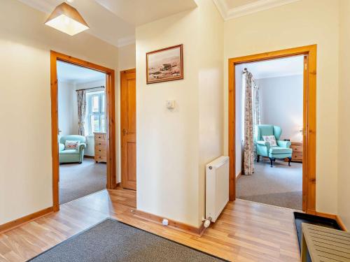 a living room with two doors and a hallway with chairs at 2 Bed in Edzell CA300 in Edzell