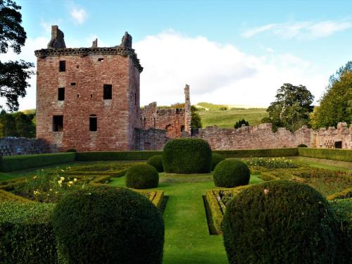 an old castle in the middle of a garden at 2 Bed in Edzell CA300 in Edzell