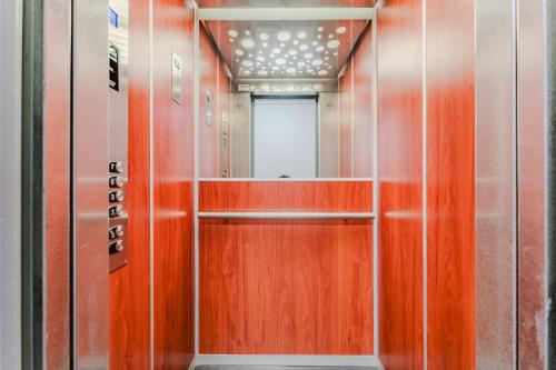 La salle de bains est pourvue d'une porte en bois et d'un miroir. dans l'établissement Magnifique 3 pièces avec Parking privé et balcon, à Lille