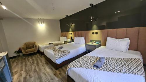 Ένα ή περισσότερα κρεβάτια σε δωμάτιο στο Aura Garden City Hotel