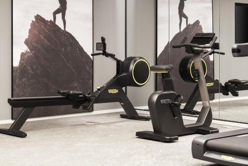 a gym with two treadmills and two exercise bikes at Intercity Hotel South Central Taiyuan in Taiyuan