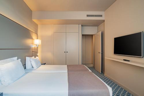 Ένα ή περισσότερα κρεβάτια σε δωμάτιο στο Hotel Dom Henrique - Downtown