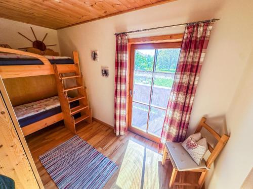 a room with two bunk beds and a window at Thalerbauer Ferienwohnungen in Wackersberg