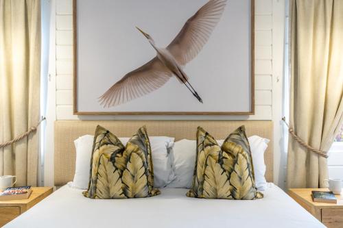a picture of a bird flying above a bed at Knysna River Club Getaways - Luxury waterfront chalets in Knysna