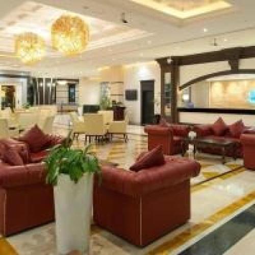 a large lobby with couches and tables at Dancenter Luxury Holiday International Dubai in Dubai