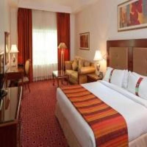 a bedroom with a large bed in a hotel room at Dancenter Luxury Holiday International Dubai in Dubai