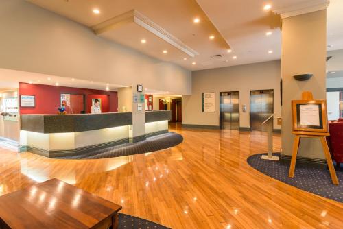 a lobby of a building with wooden floors at Scenic Hotel Southern Cross in Dunedin