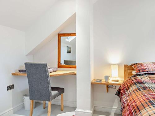 a bedroom with a desk and a bed and a mirror at 2 Bed in Arthog 90777 in Arthog