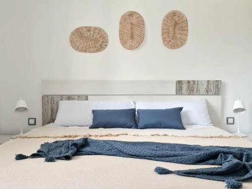 a bedroom with a bed with a blue blanket on it at Sea Arenales del Sol in Arenales del Sol