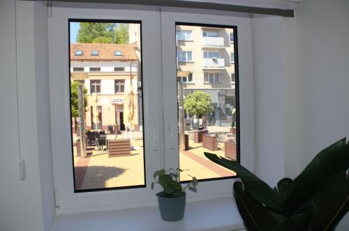 a window with a view of a city street at Mazvydo studio appartment in Klaipėda