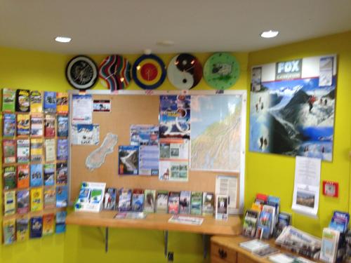 a book store with a display of books and signs at Ivorytowers Accommodation in Fox Glacier