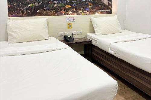 Postel nebo postele na pokoji v ubytování Sugbutel Family Hotel Cebu powered by Cocotel