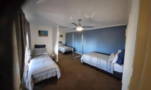 a hotel room with two beds and a mirror at Lavender Cottage at Nannup Lavender Farm in Nannup Mill