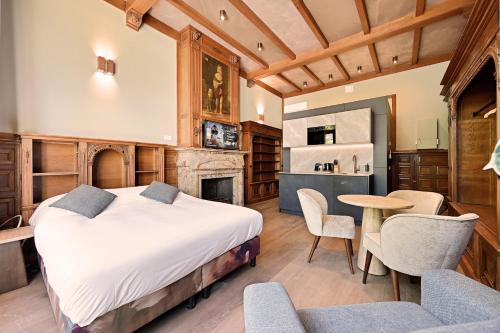 a bedroom with a bed and a table and chairs at novallure nassau residence in The Hague