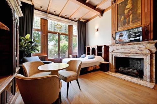 a bedroom with a bed and a fireplace at novallure nassau residence in The Hague