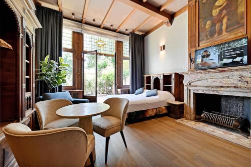 a bedroom with a bed and a fireplace at novallure nassau residence in The Hague