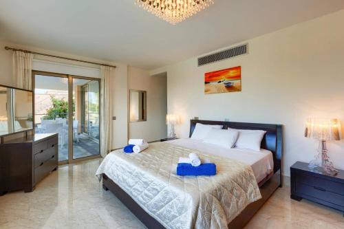 a bedroom with a bed with two blue boxes on it at Villa Pandora Limni by Villa Plus in Mavroli