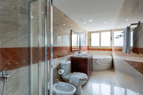 a bathroom with a toilet and a sink and a shower at Villa Pandora Limni by Villa Plus in Mavroli