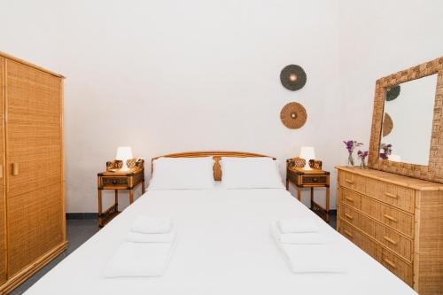 a bedroom with a large bed and two night stands at CASA PAPADIA in Uggiano la Chiesa