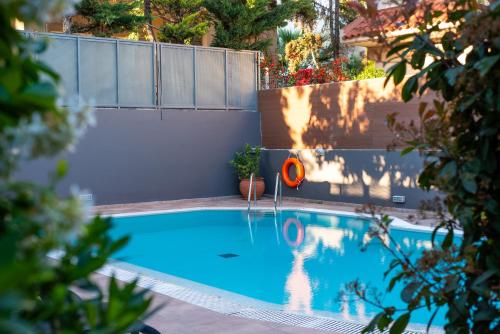 a swimming pool with a red frisbee in it at DreamCoast Apartments I in Artemida