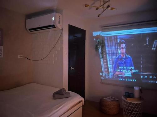 a room with a tv and a bed in a room at Korean Themed 1BR Staycation in Marilao Bulacan in Marilao