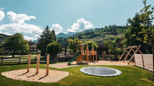 a playground in a yard with a play equipment at Apparthaus & Chalets Hofer in Zell am Ziller