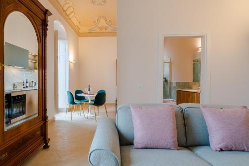 a living room with a couch and a table at Palazzo Pupillo fine apartments by Dimore in Sicily in Siracusa