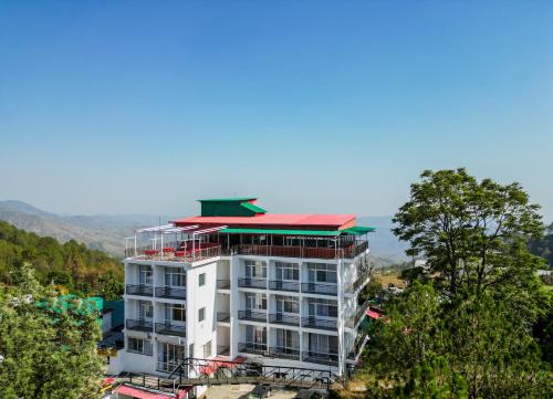 a white building with a red roof on top of it at Ai 360 Degree Hotel Lansdowne in Lansdowne