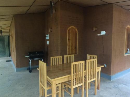 a dining room with a wooden table and chairs at Kirindioya Village Safari Lodge in Tanamalwila