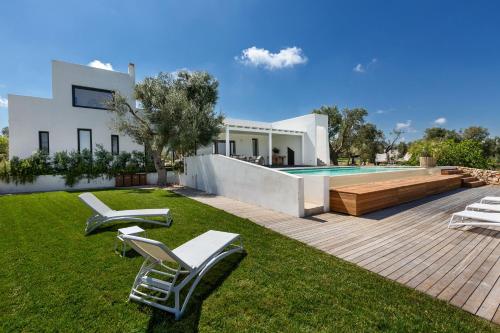 a villa with a swimming pool and lawnitures at Villa Libe by Perle di Puglia in Specchiolla 