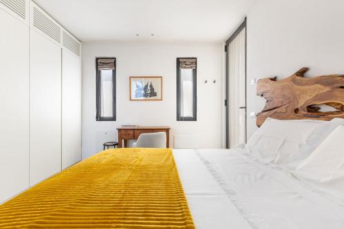 a bedroom with a large bed with a yellow blanket at Villa Libe by Perle di Puglia in Specchiolla 