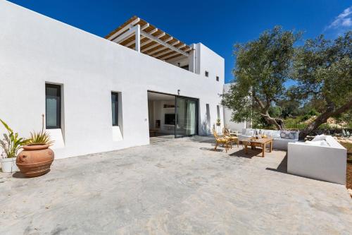 a white villa with a large patio at Villa Libe by Perle di Puglia in Specchiolla 