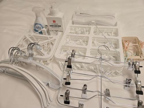 a white sink with hoses and bottles on a table at MIKASA guesthouse in Tokyo