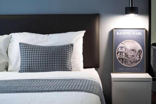 a bedroom with a bed and a picture of a building at Heritage Collection on Boon Tat in Singapore