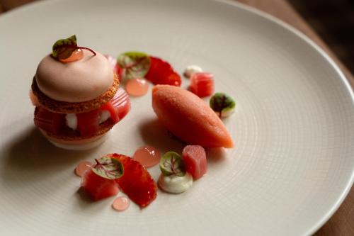 a white plate with a dessert with strawberries and a carrot at Shibden Mill Inn in Halifax
