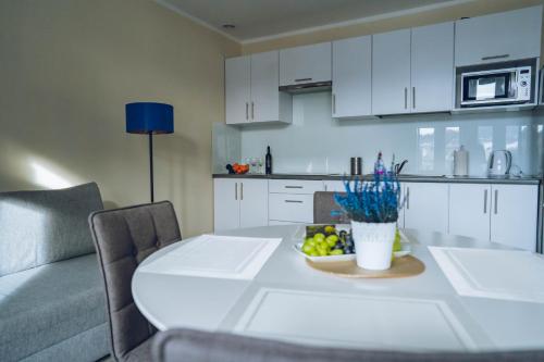 a kitchen with a table with a bowl of fruit at Apartamenty ABRACADABRA in Ustroń