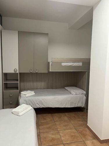 a small bedroom with two beds and a cabinet at Sammit holiday home in Michelica