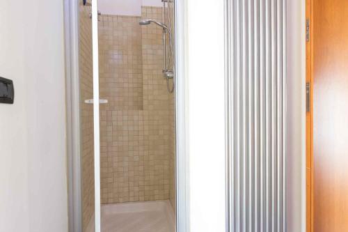 a bathroom with a shower with a glass door at Sammit holiday home in Michelica