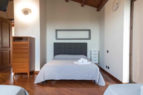 a bedroom with a bed with two towels on it at Sammit holiday home in Michelica
